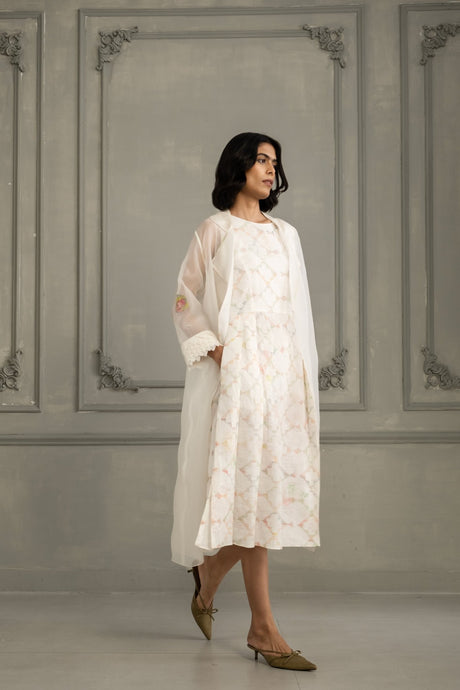 Model walking in the sheer ivory organza jacket over the printed linen midi dress, front view