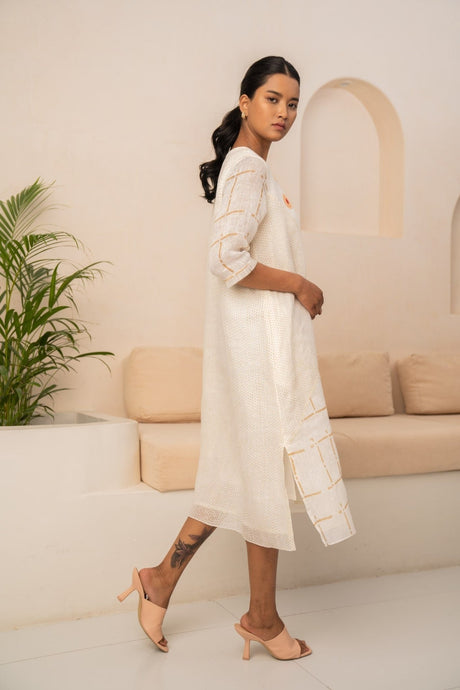 Model walking in the ivory check linen dress with split hem, three-quarter view