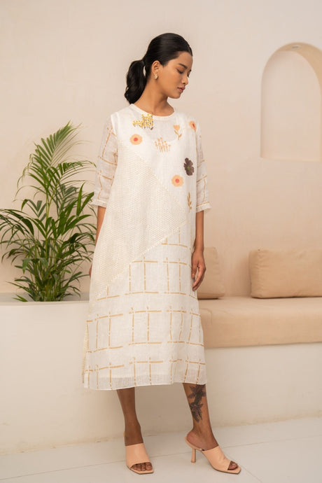 Model wearing the ivory check linen dress with embroidered flowers on the bodice, front view