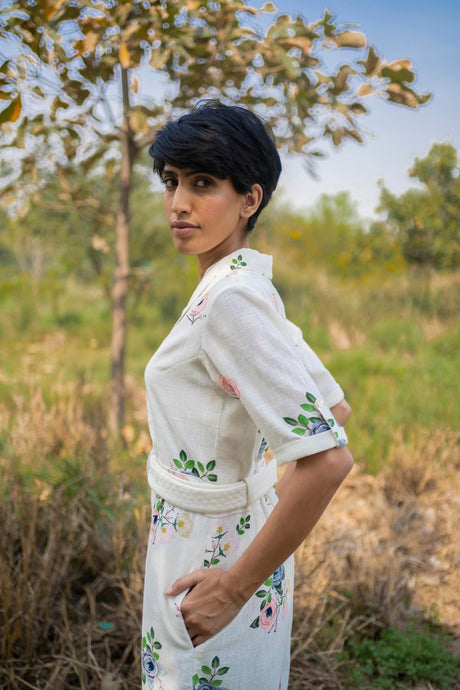 Ivory Jumpsuit side view with belted waist, model with hand in pocket