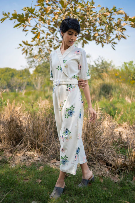 Model wearing the ivory embroidered jumpsuit outdoors, full length front view