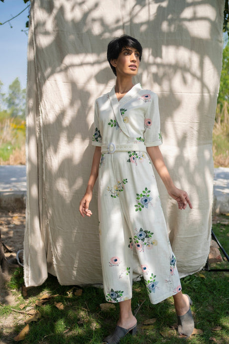 Ivory Jumpsuit from ARCVSH by Pallavi Singh with wrap collar, floral embroidery and tie belt, front view