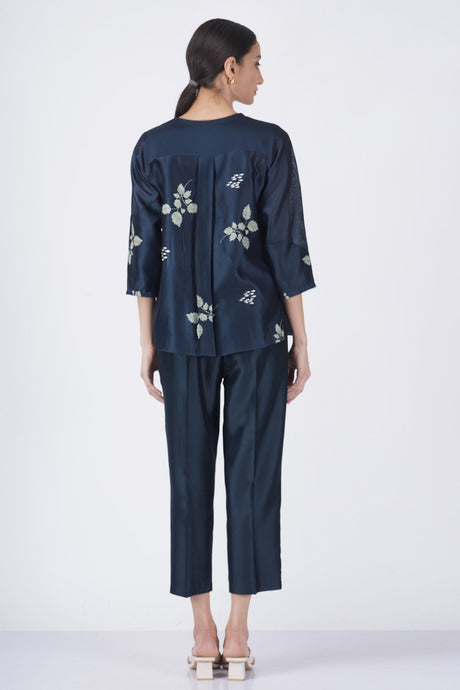 Leaf printed front pleated shirt with solid pant back view, model wearing the set