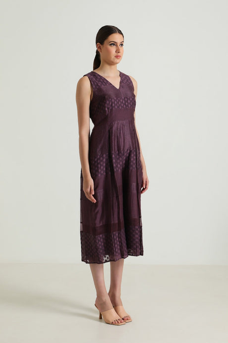 Model wearing the plum Lavender Lace Jumpsuit with wide cropped legs, three-quarter side view