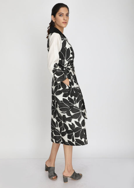 Model wearing the Lotus print midi dress with tie belt, three-quarter back view