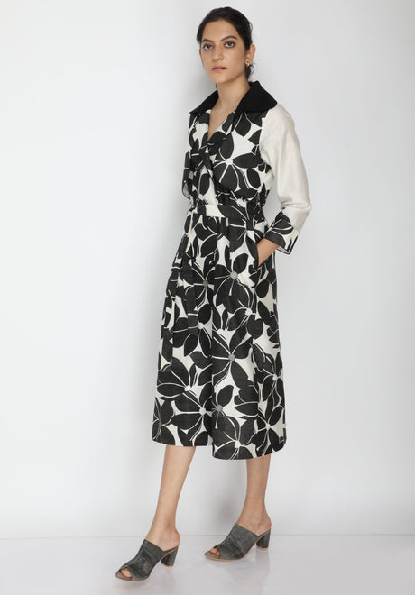 Lotus print dress with pockets and black collar, model with hand in pocket, three-quarter front view