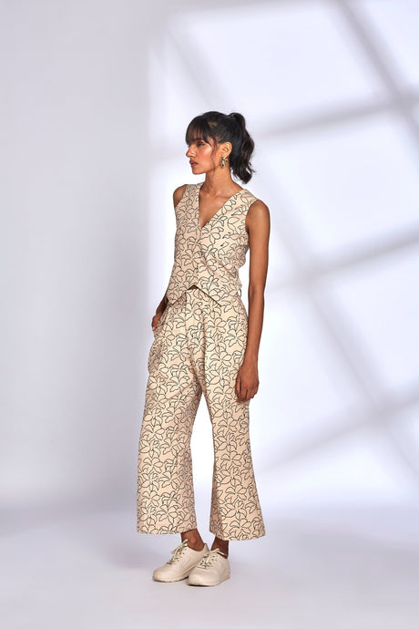 Mara Co-ord Set with pointed waistcoat hem and hands in pockets, three quarter view