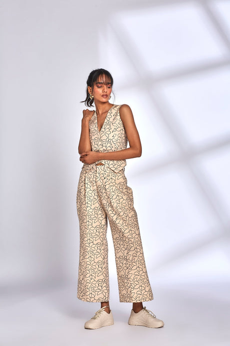 Model wearing the Mara Co-ord Set with arms folded and white sneakers, front view