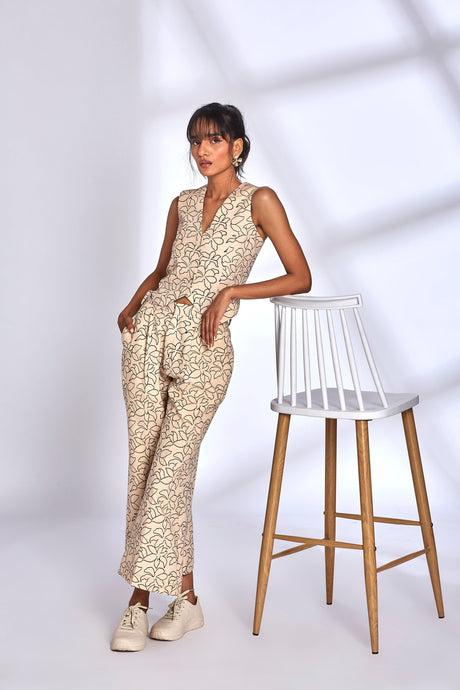 Model leaning on a stool in the Mara Co-ord Set, full length front view