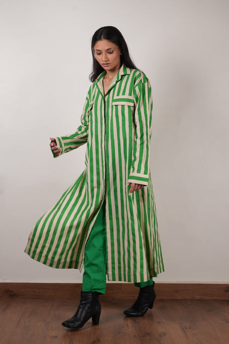 Model walking in the green striped tunic showing the side slit and green pants