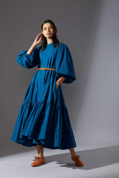 Model posing in the belted blue Kaavya dress with gathered tier, front view