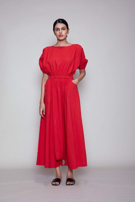 Model wearing the Mati Sphara Jumpsuit in Red, front view showing the boat neck and gathered waist
