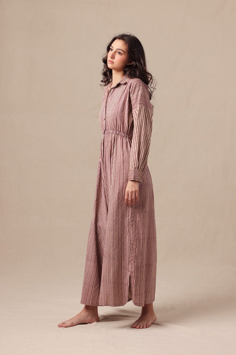 Model wearing the Mauve Striped Shirt Sphara Jumpsuit, three quarter view showing the long sleeves