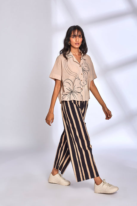 Model walking in the Meadow Co-ord Set showing the striped wide pants, side view