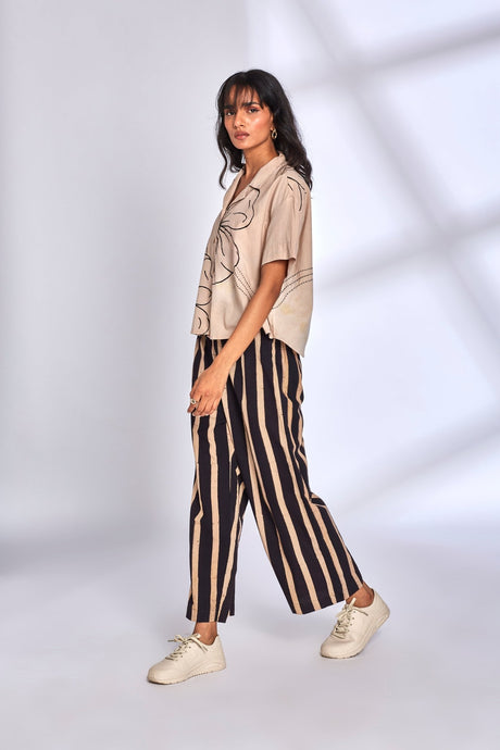 Side view of the Meadow Co-ord Set in motion with striped wide leg pants