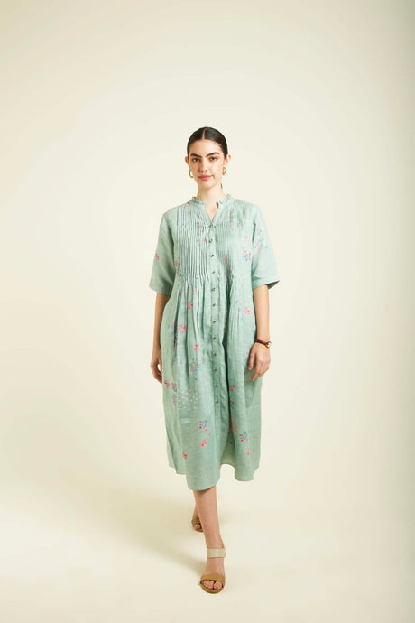 Mint linen printed dress walking front view showing the gathered midi skirt