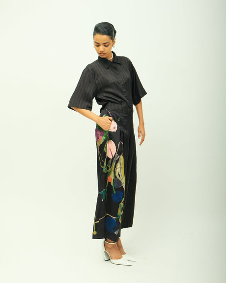 Psyflora shirt set with a hand in the trouser pocket showing the painted floral leg, front view