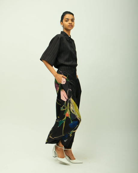 Psyflora Shirt set by Ofrida, black pinstripe shirt with wide trousers painted with a floral design, side view