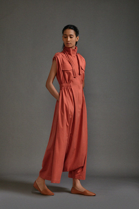 Rust Safari Sphara Jumpsuit, three quarter front view with the funnel neck tie