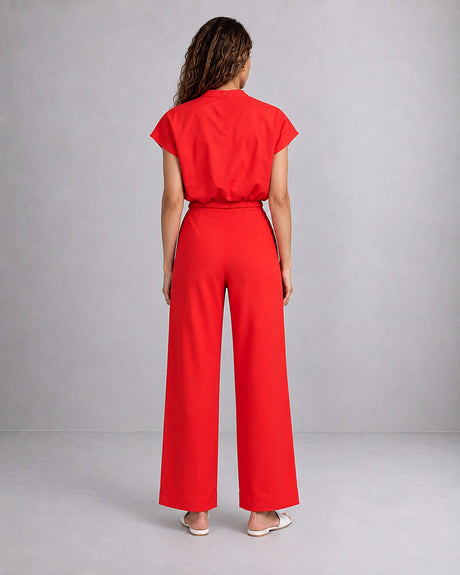 Model wearing the red Sphara Cotton Top with red trousers, back view