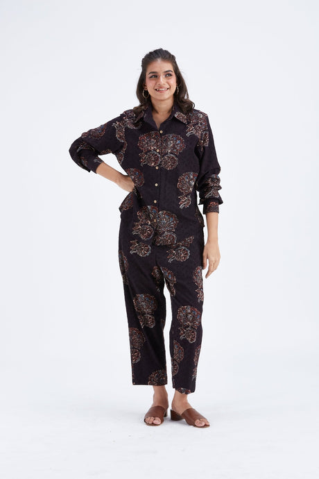 Yuna Black co-ord set with hand on hip showing the button front shirt, front view