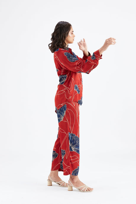 Side view of the red Yuna co-ord set showing the relaxed shirt and pants