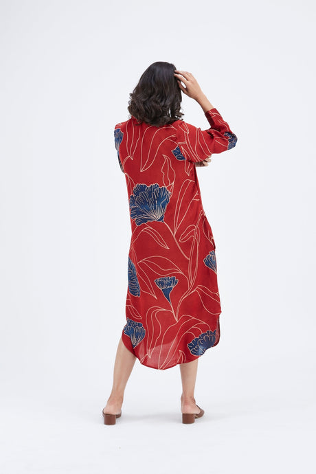 Side back view of the red Zae dress with hand in hair and curved hem
