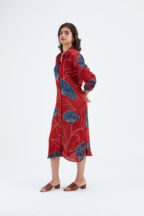 Red Zae dress with hand on hip showing the long sleeves, three quarter view