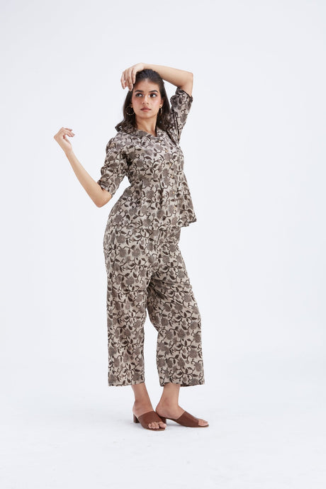 Model posing with arm raised in the Zola Beige co-ord set, full length front view